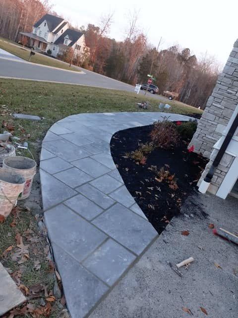 A sidewalk is being built in front of a house