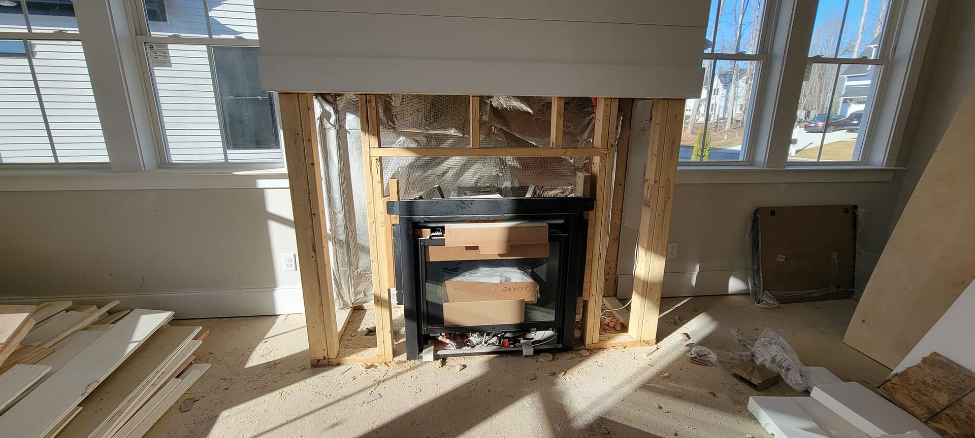 A fireplace is being built in a living room in a house.