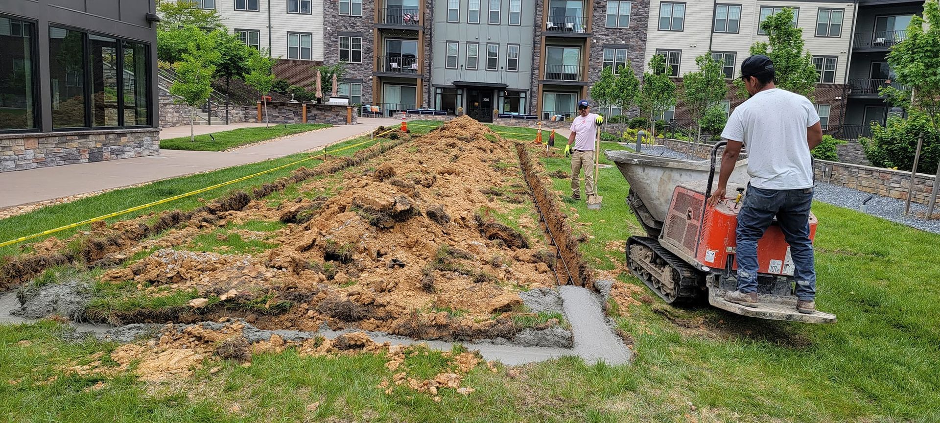 A man is using a machine to dig a hole in the ground.