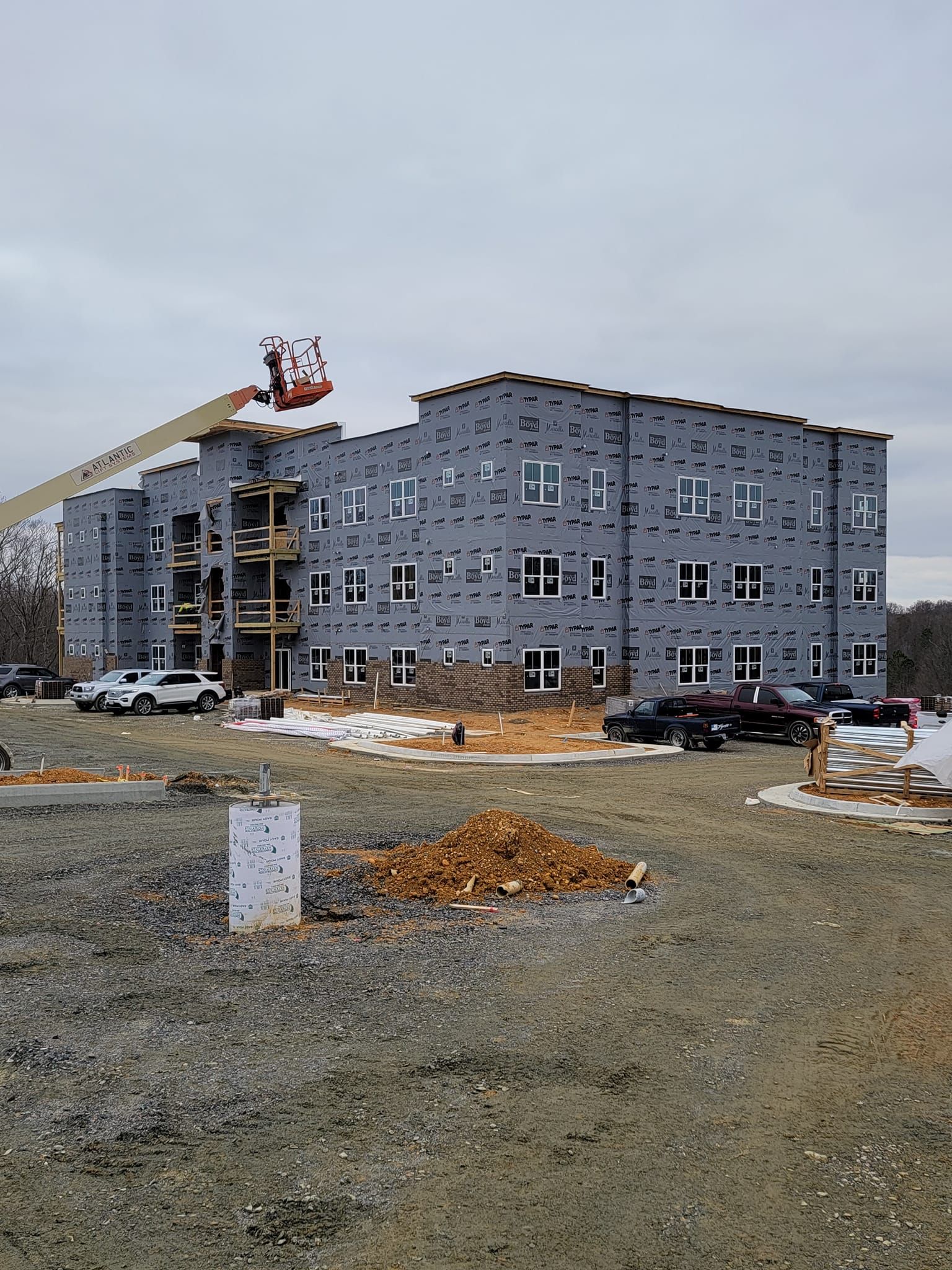 A large building under construction with a crane in front of it.