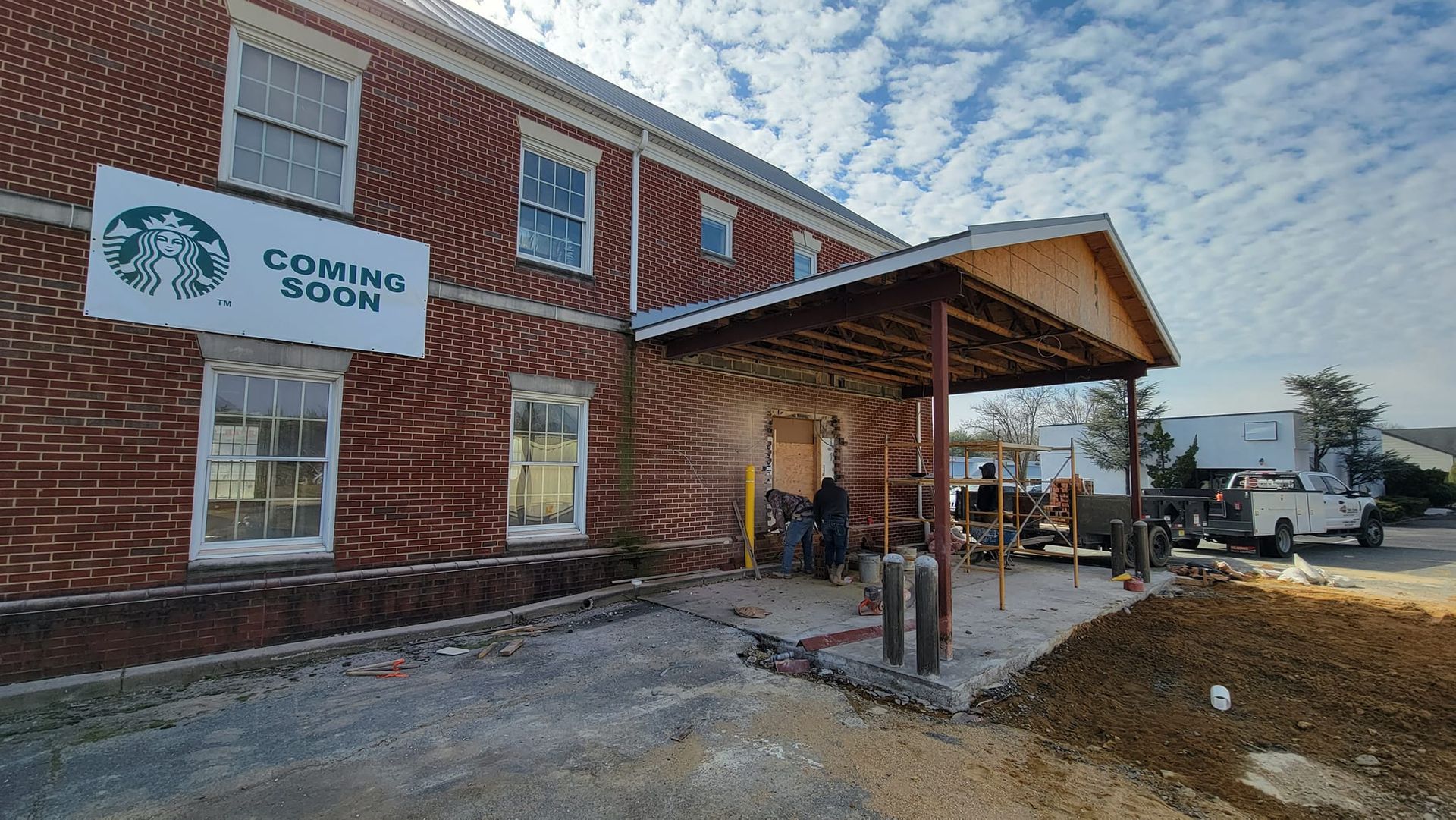 A brick building with a sign that says coming soon