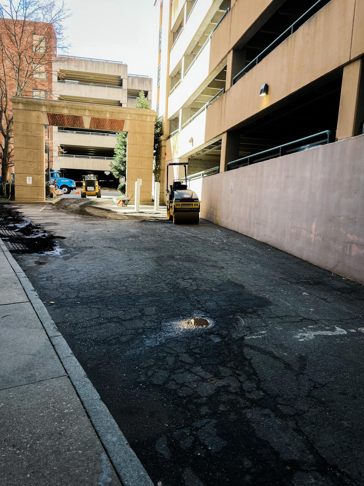 A parking lot with a roller in the middle of it