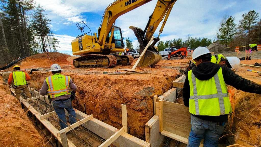 A group of construction workers are working on a construction site.