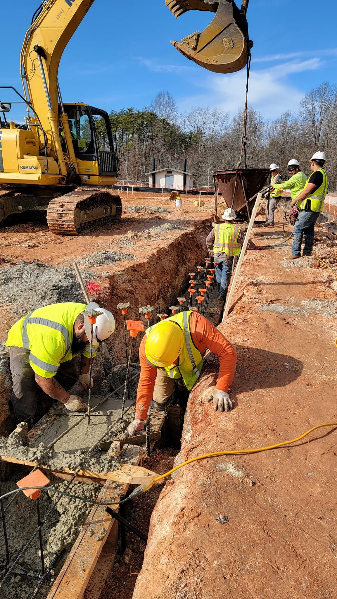 A group of construction workers are working on a construction site.