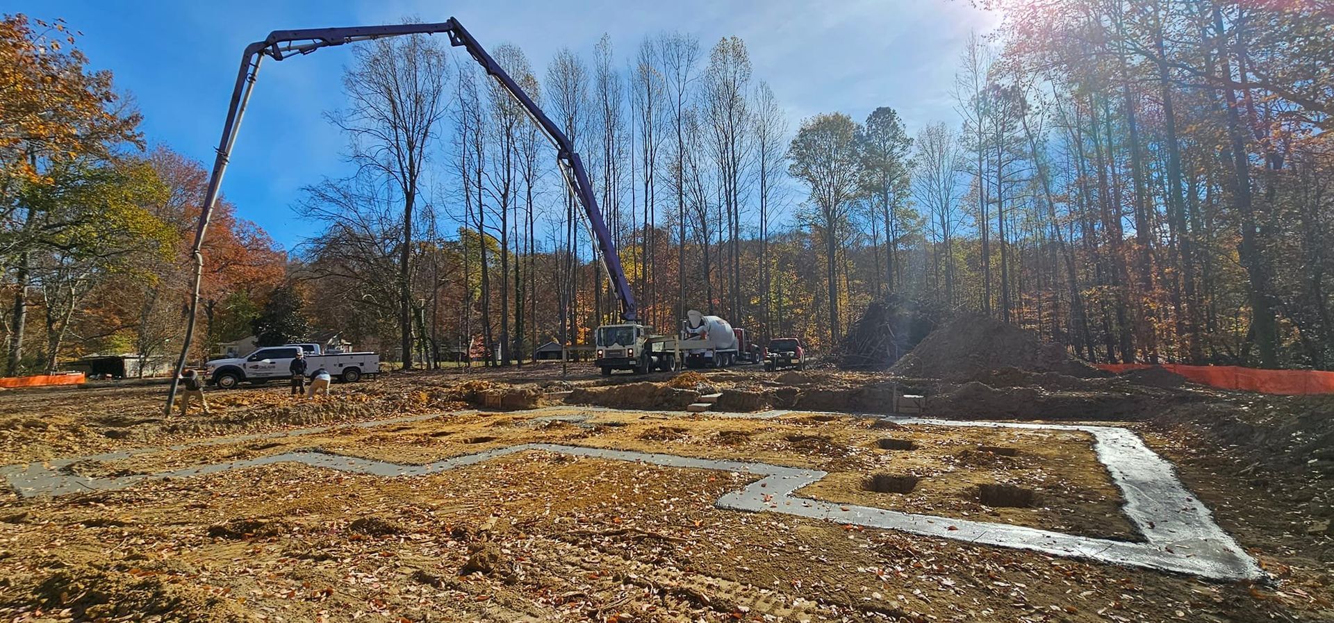 A construction site with a concrete pump in the middle of it.