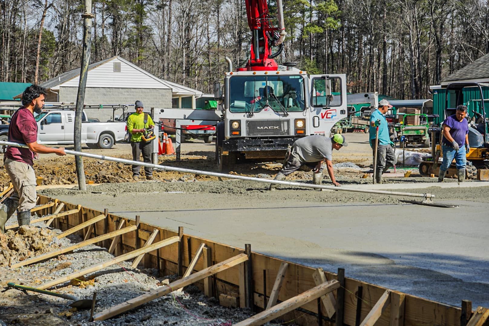 A Group of Construction Workers Are Working on a Concrete Driveway