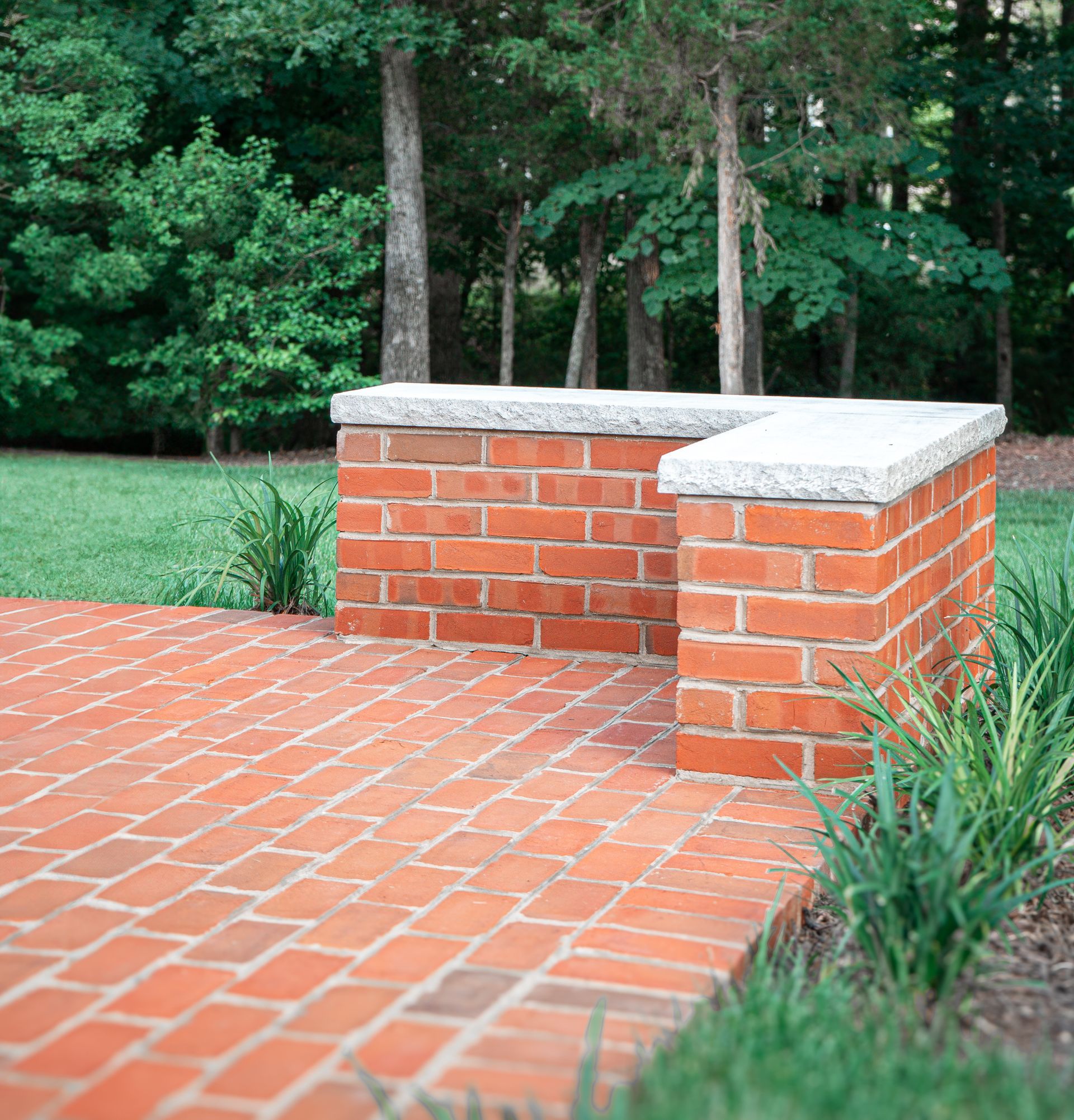 A Brick Walkway With a Brick Pillar in the Middle