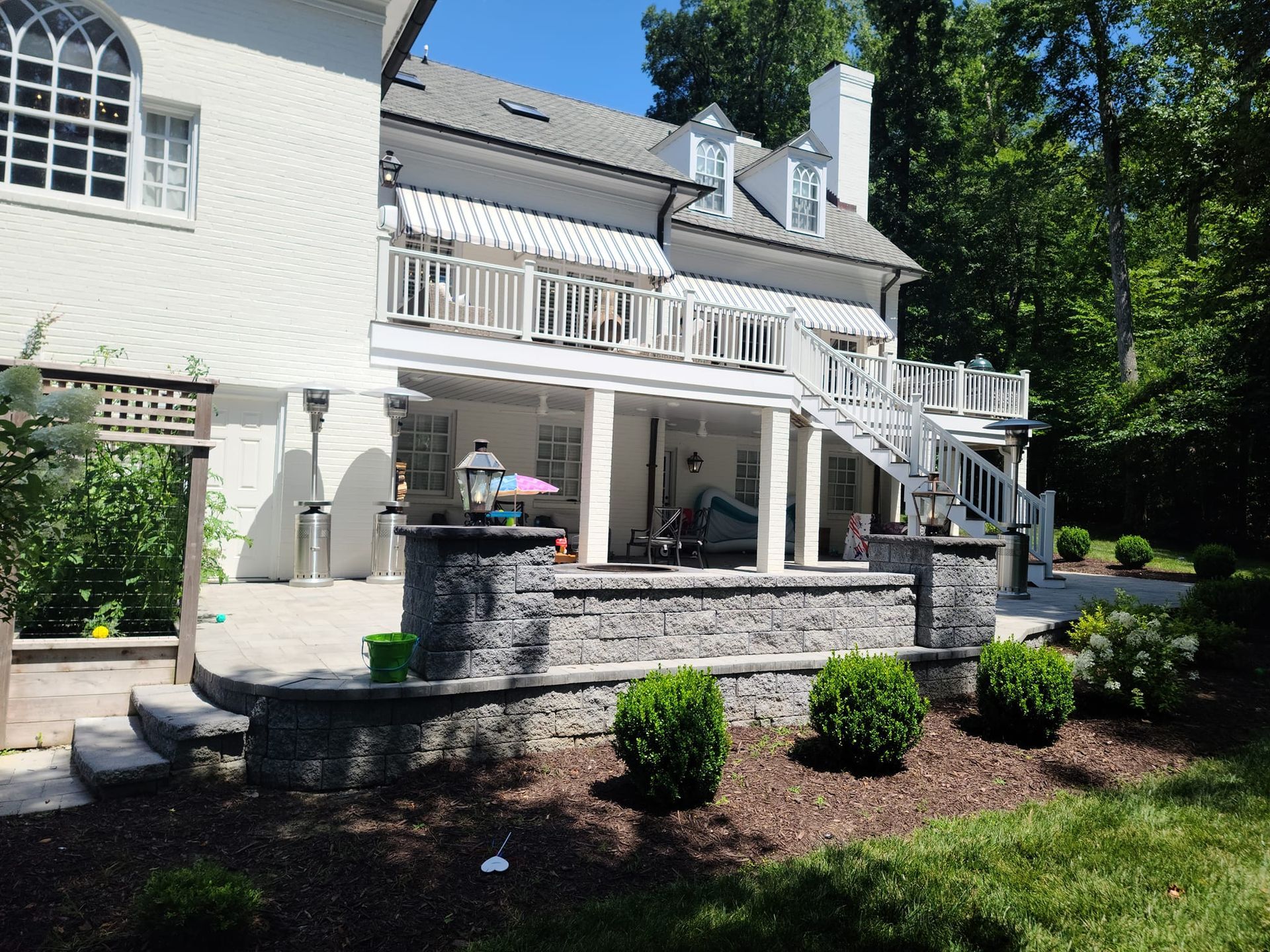 A large white house with a patio and stairs