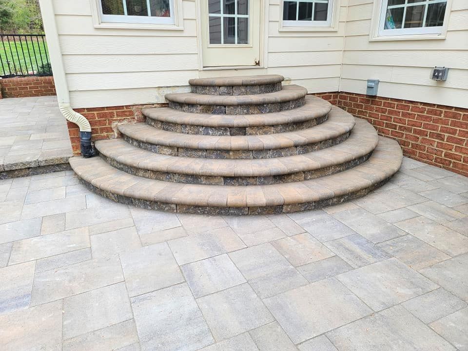 A set of stairs leading up to a house on a patio.