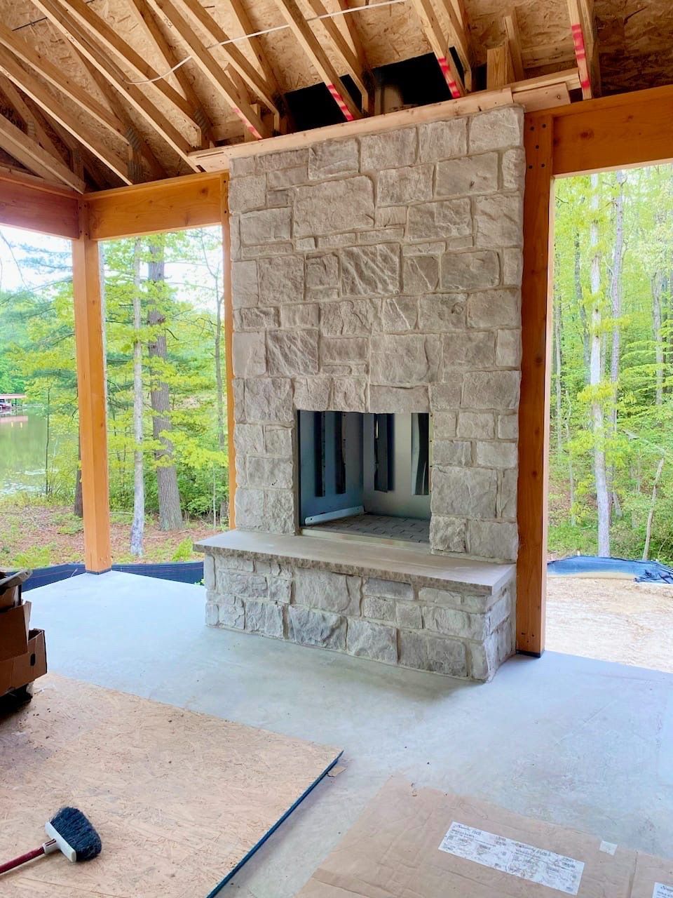 A Stone Fireplace is Being Built in a House Under Construction