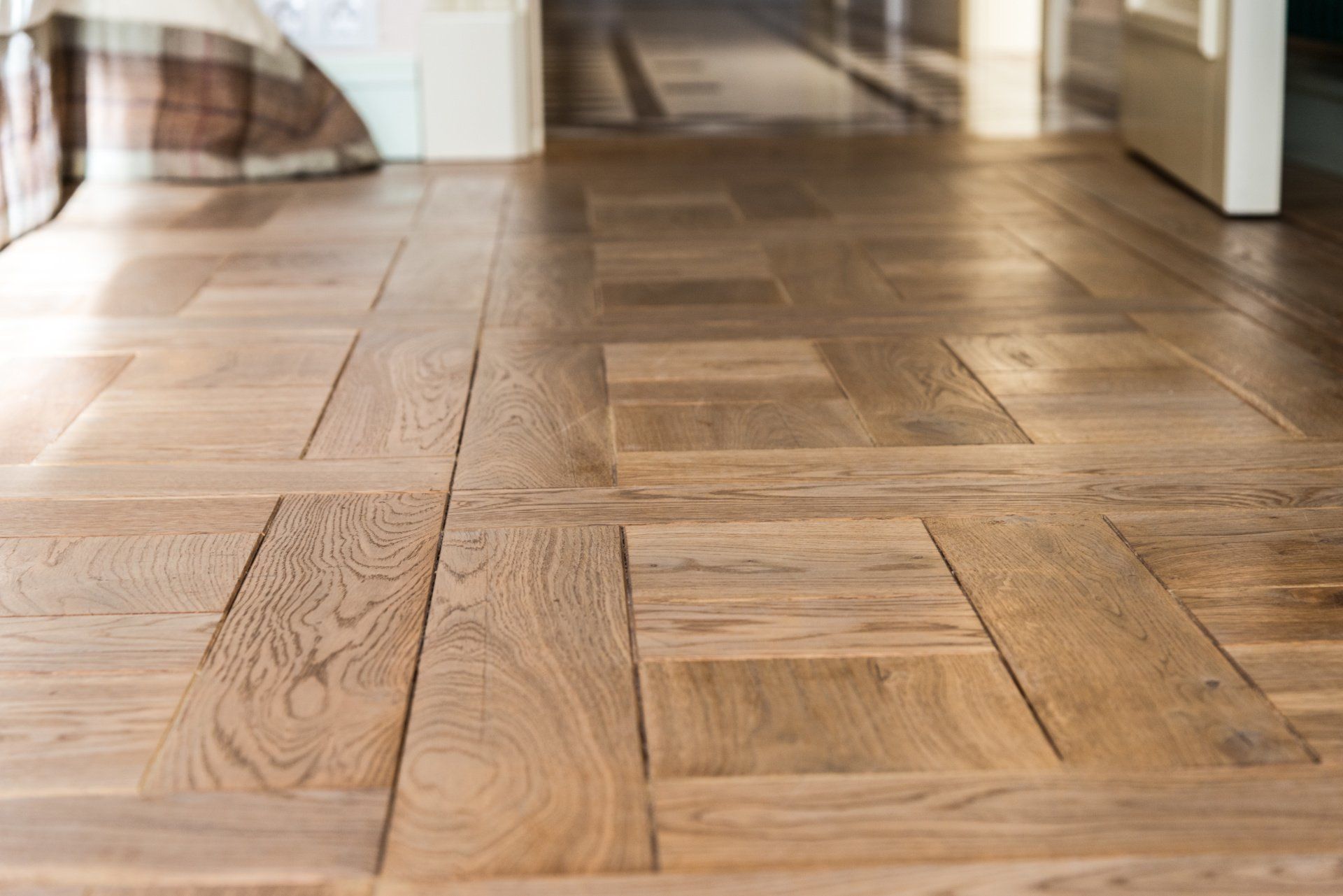 A close up of a wooden floor in a hallway.
