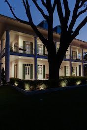 A large house with a tree in front of it at night. Portfolio for Premier Lighting & Home Automation, LLC in Dallas Fort Worth (DFW).