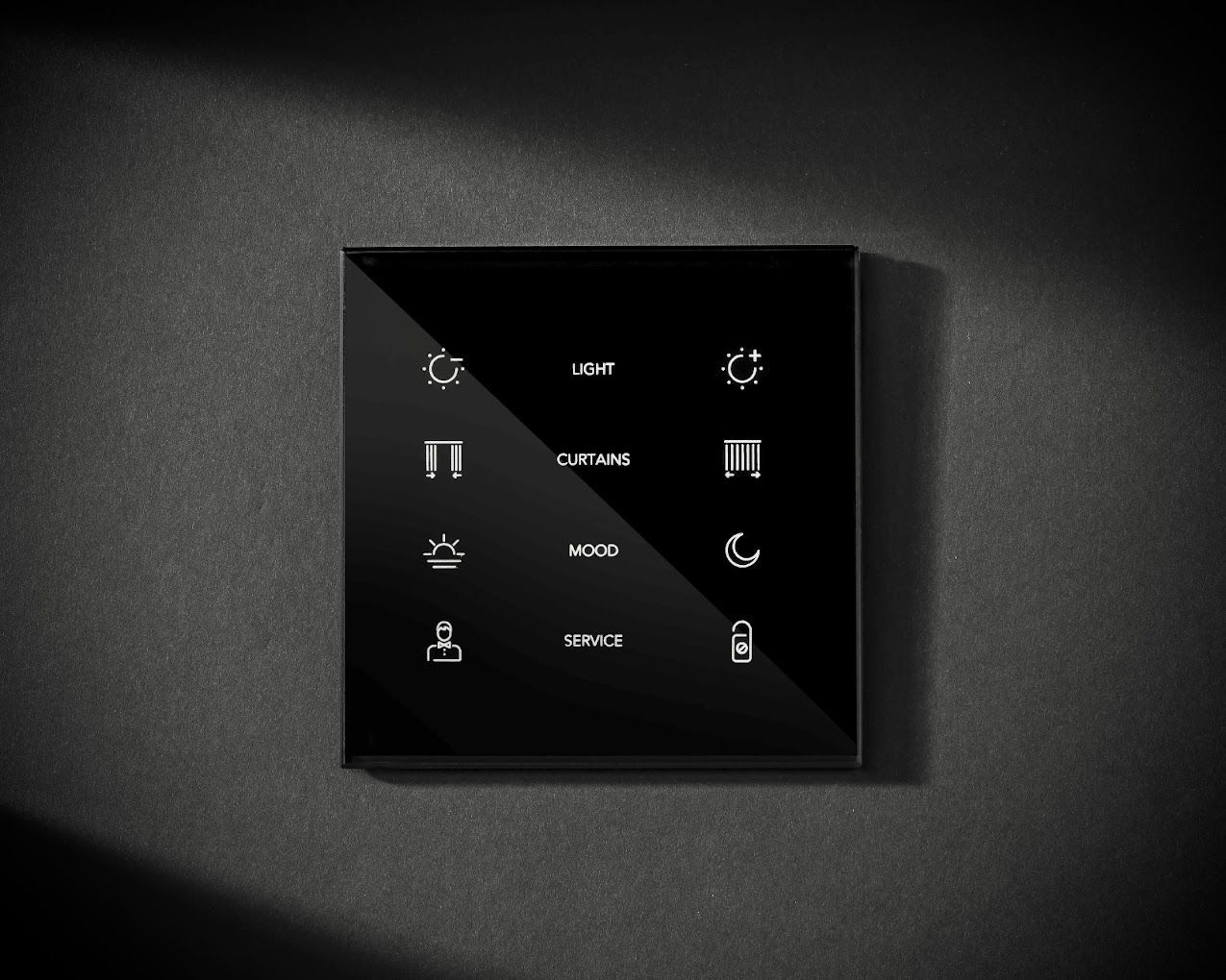 A black light switch on a black wall.