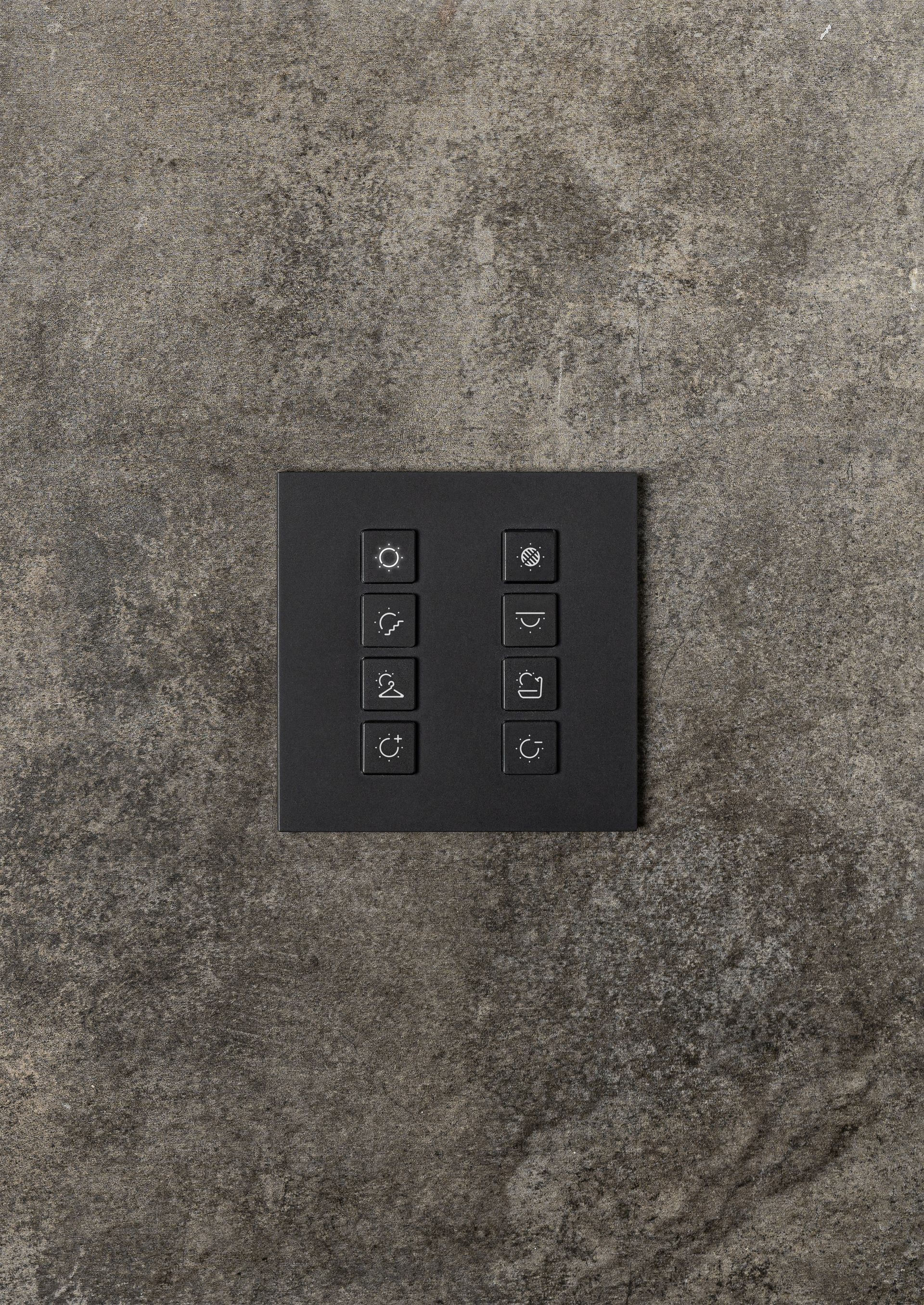 A close up of a black light switch on a wall.