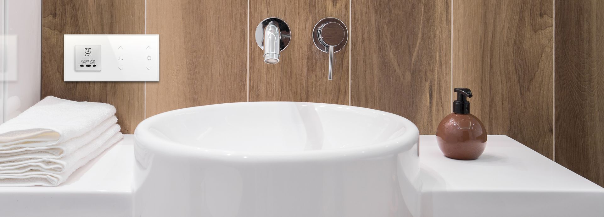 A bathroom with a sink and a bottle of soap on the counter. Portfolio for Premier Lighting & Home Automation in Dallas Fort Worth (DFW).