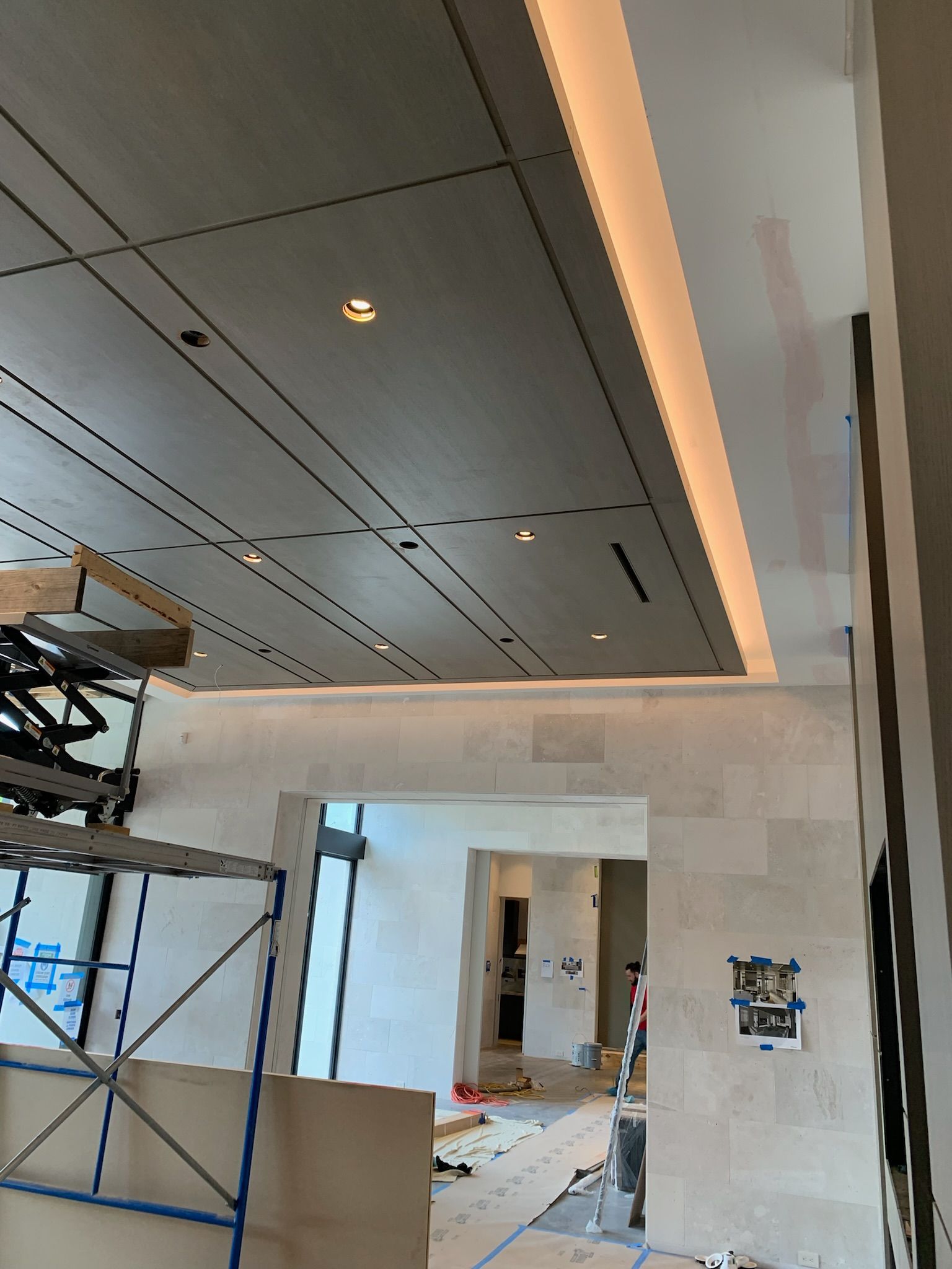 A large room with a ceiling that is being built. 
