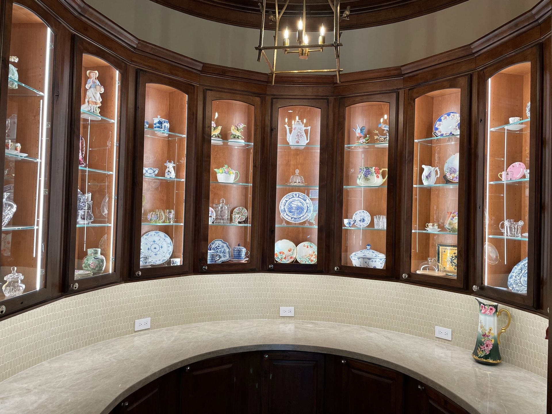 A room with a lot of shelves and plates on them.  