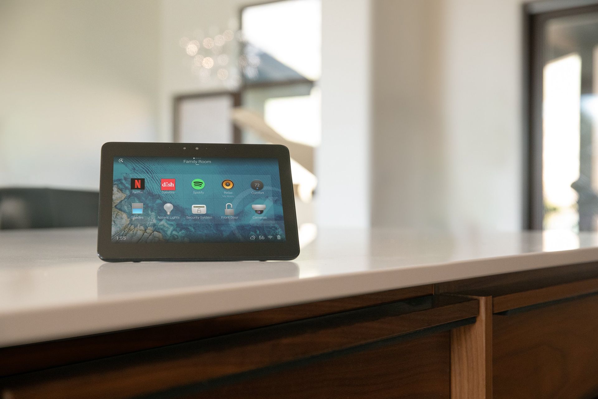 A tablet is sitting on top of a counter in a kitchen. Premier Lighting & Home Automation in Dallas Fort Worth (DFW).