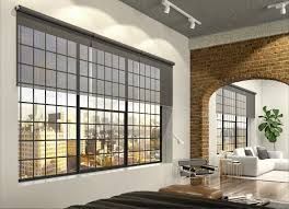 A living room with a large window and a brick wall. Premier Lighting & Home Automation in Dallas Fort Worth (DFW).