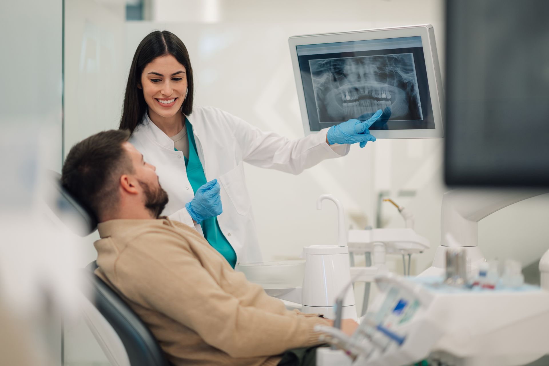 Dentist showing teeth x-ray to patient