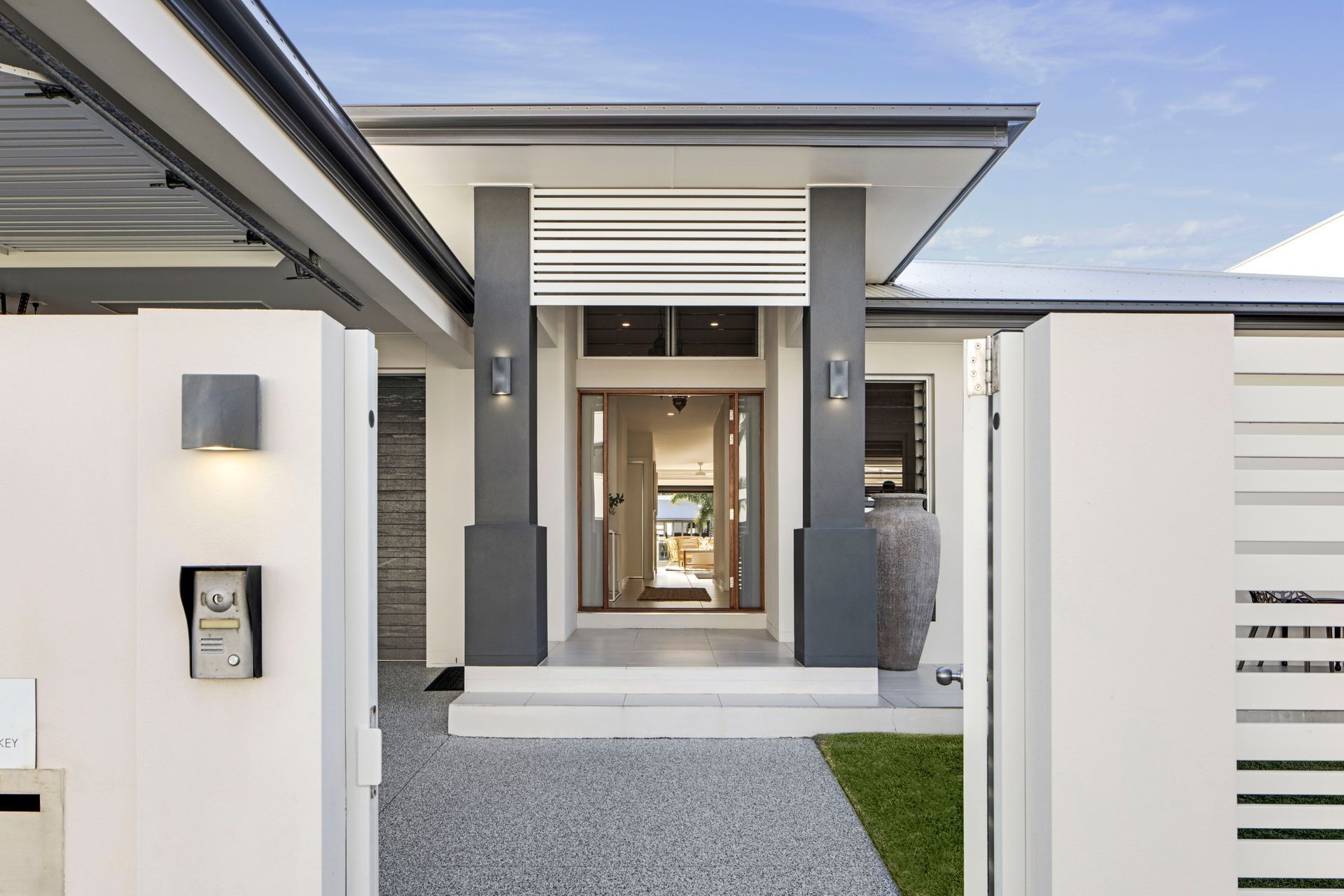 A View Through a White Gate Showing the Entrance — Michael Duncan Constructions Pty Ltd in Robina, QLD