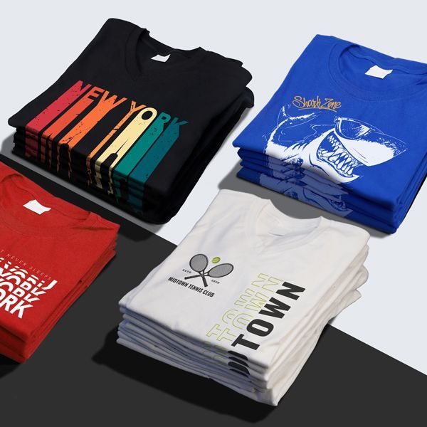 A stack of t-shirts with one that says new york on it
