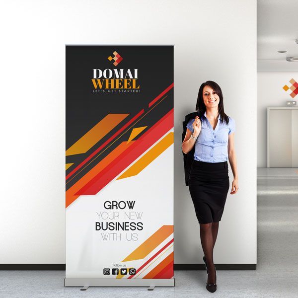 A woman is standing in front of a domai wheel banner