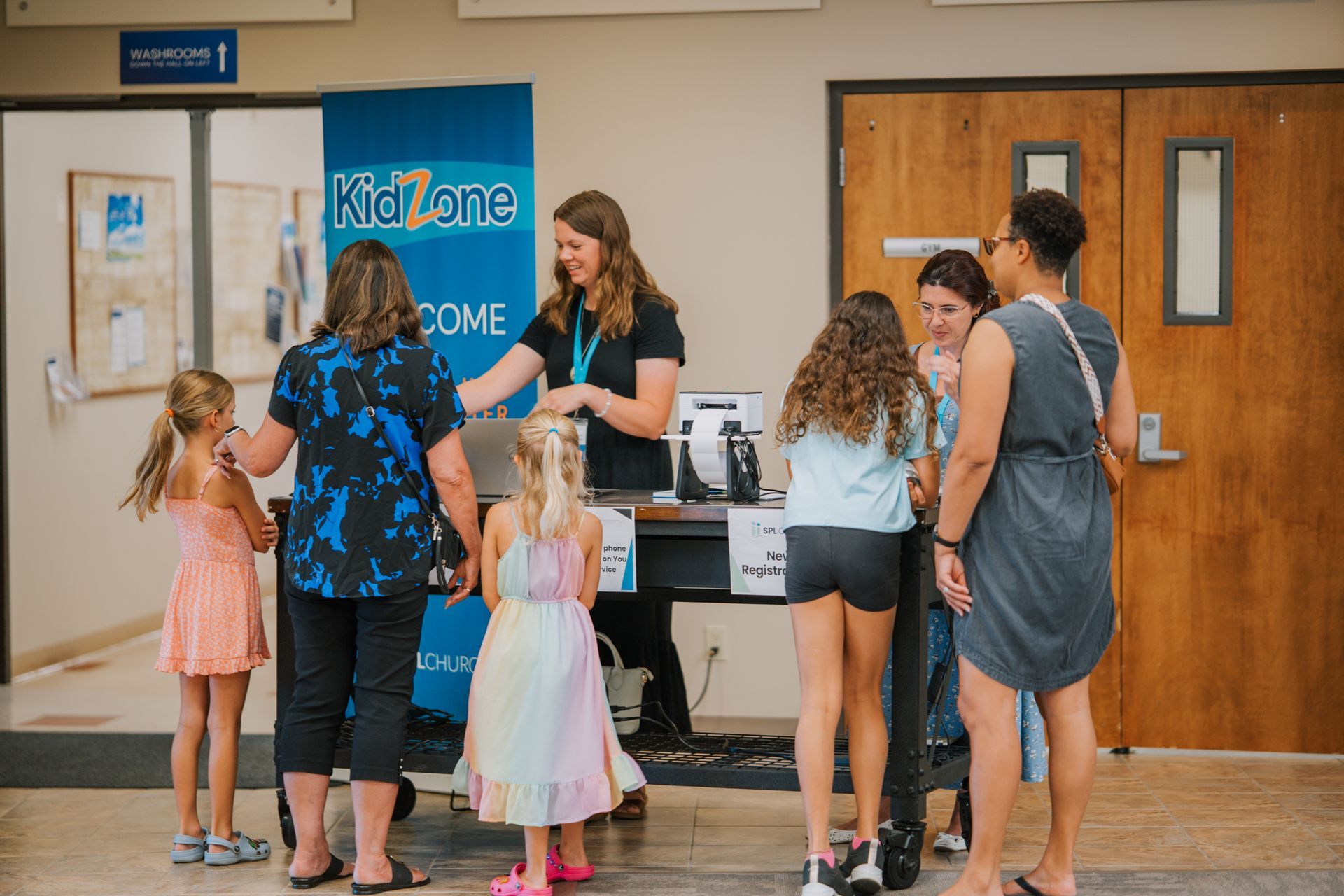 People registering children at a