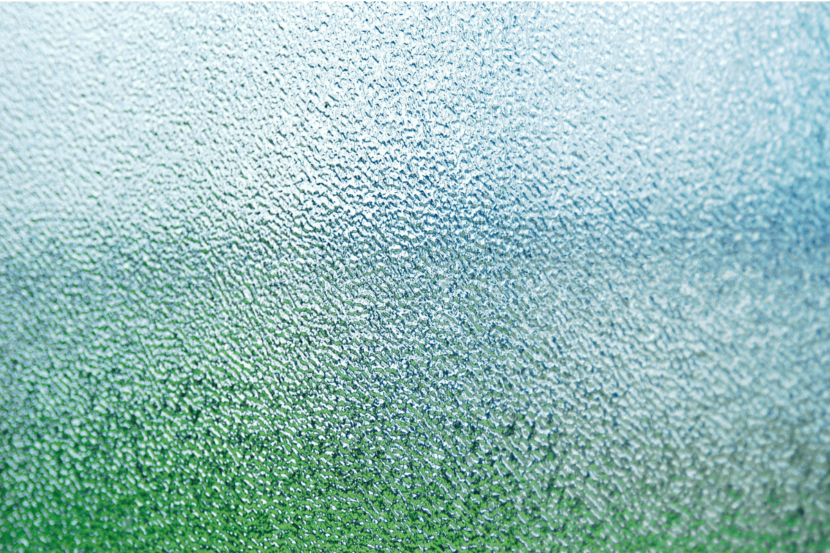 Abstract frosted glass texture fading from green at the bottom to pale blue-white at the top.