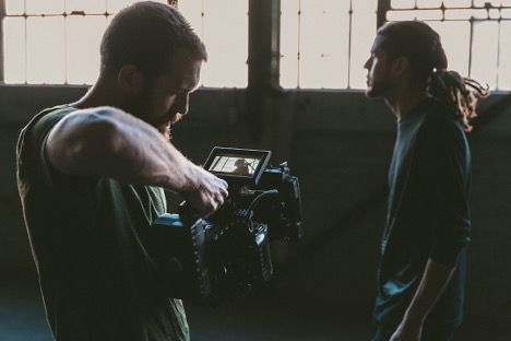 camera filming a person standing