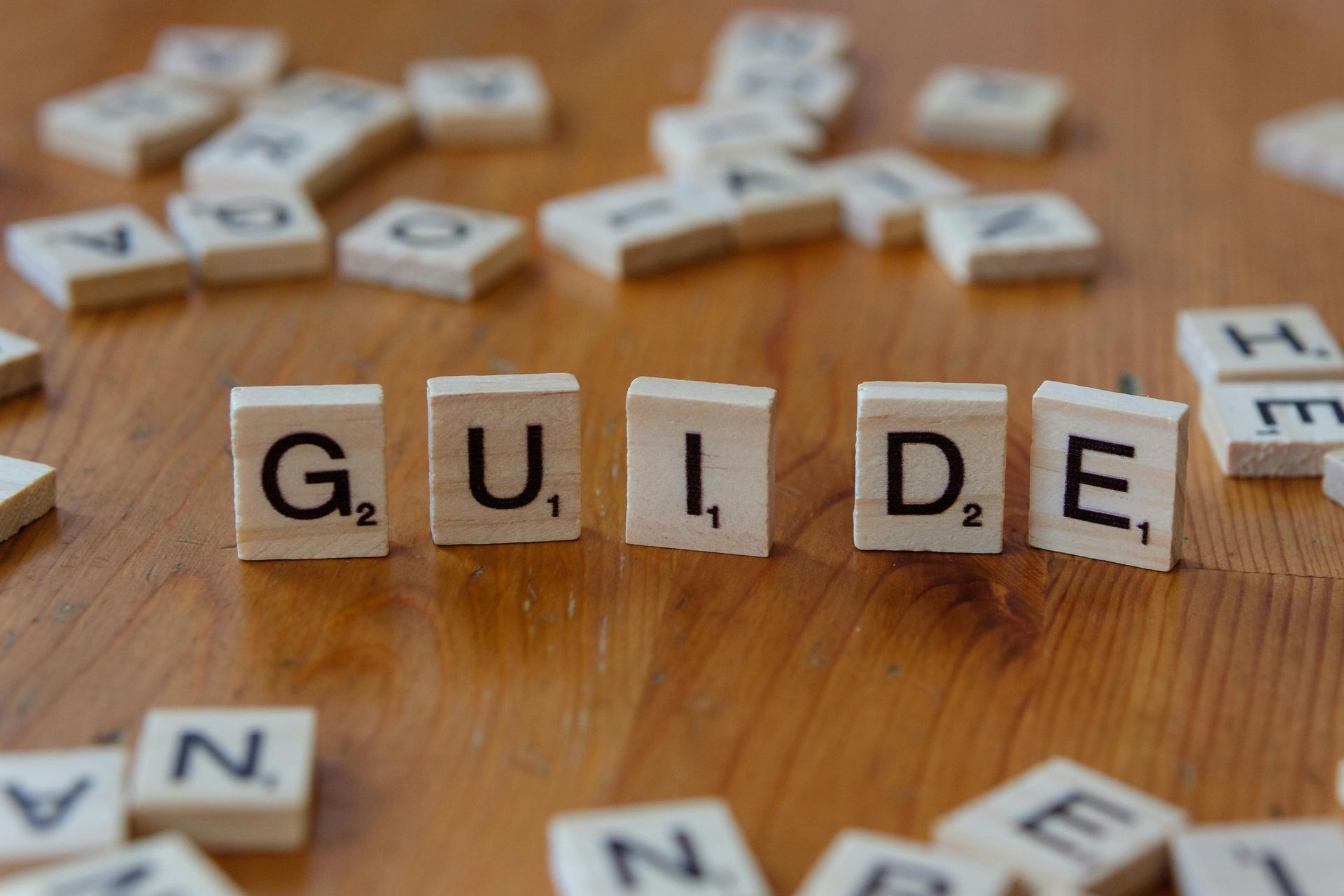 Scrabble tiles on a wooden surface spelling the word