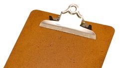 Brown clipboard with silver metal clip on a white background