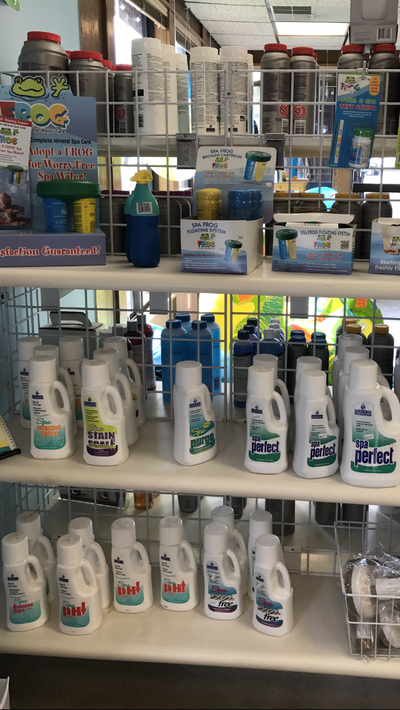 Store shelf with assorted cleaning supplies and detergent bottles in a retail aisle