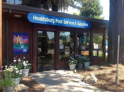 Storefront for Healdsburg Pool Service & Supplies with open sign and potted plants