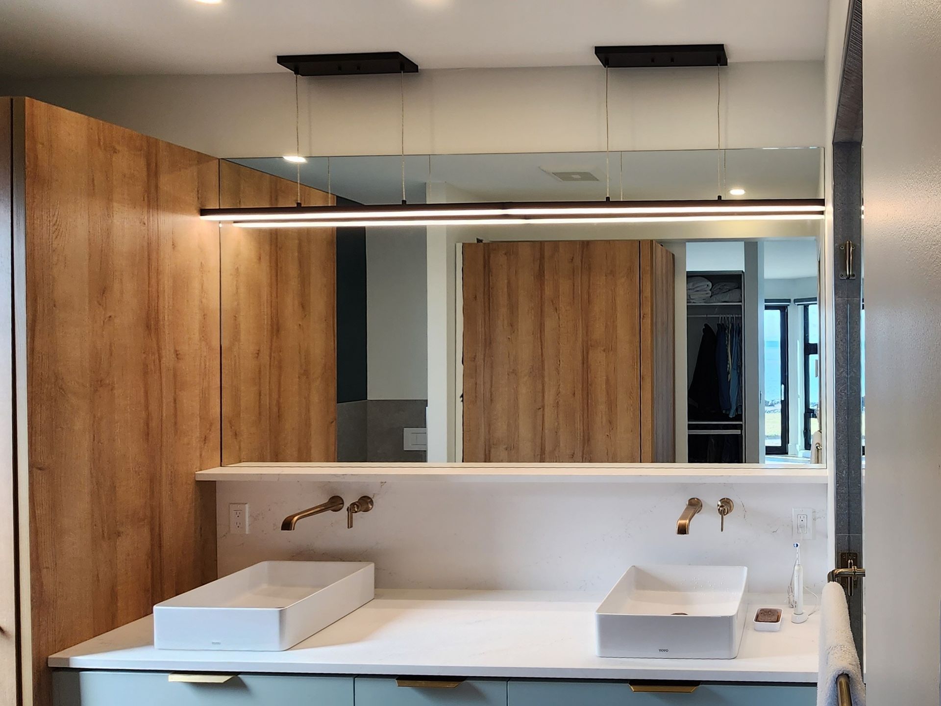 A bathroom with a sink and a large mirror