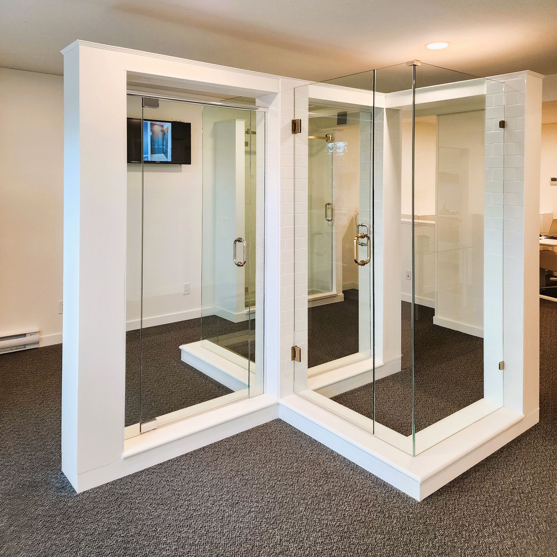 A room with mirrors and a tv on the wall
