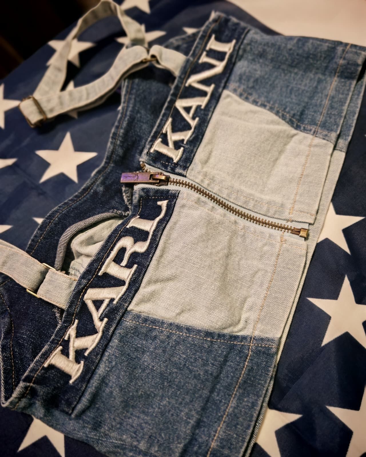 Primo piano di capi in denim con motivi a stelle bianche e il marchio