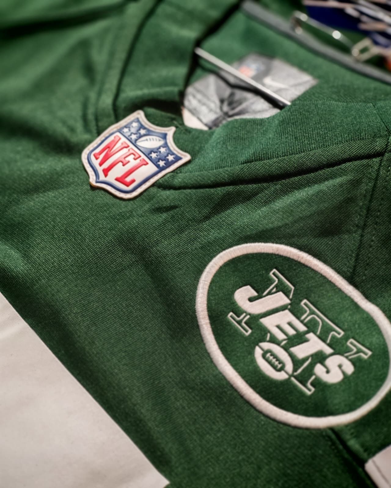 Maglia verde dei New York Jets della NFL con logo della squadra e scudo NFL in primo piano