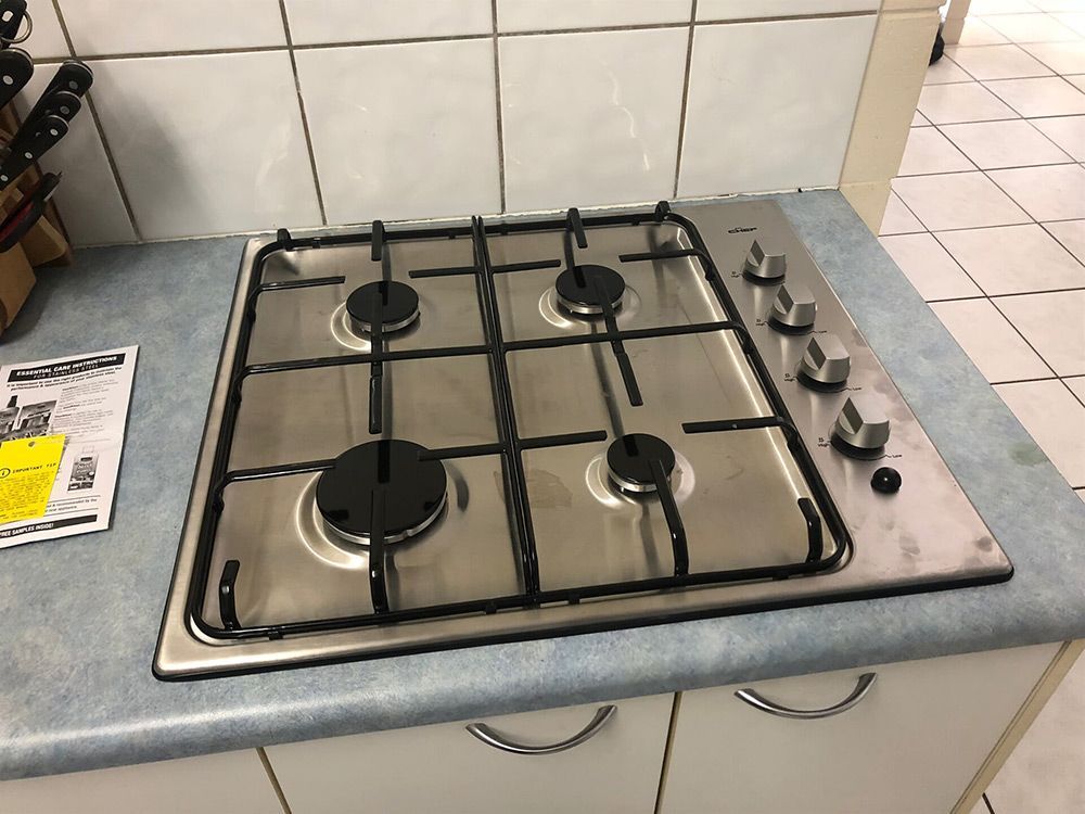 A Stove top oven is Sitting on top of a Kitchen Counter — Plumbers & Gas Fitters in Coconut Grove, NT