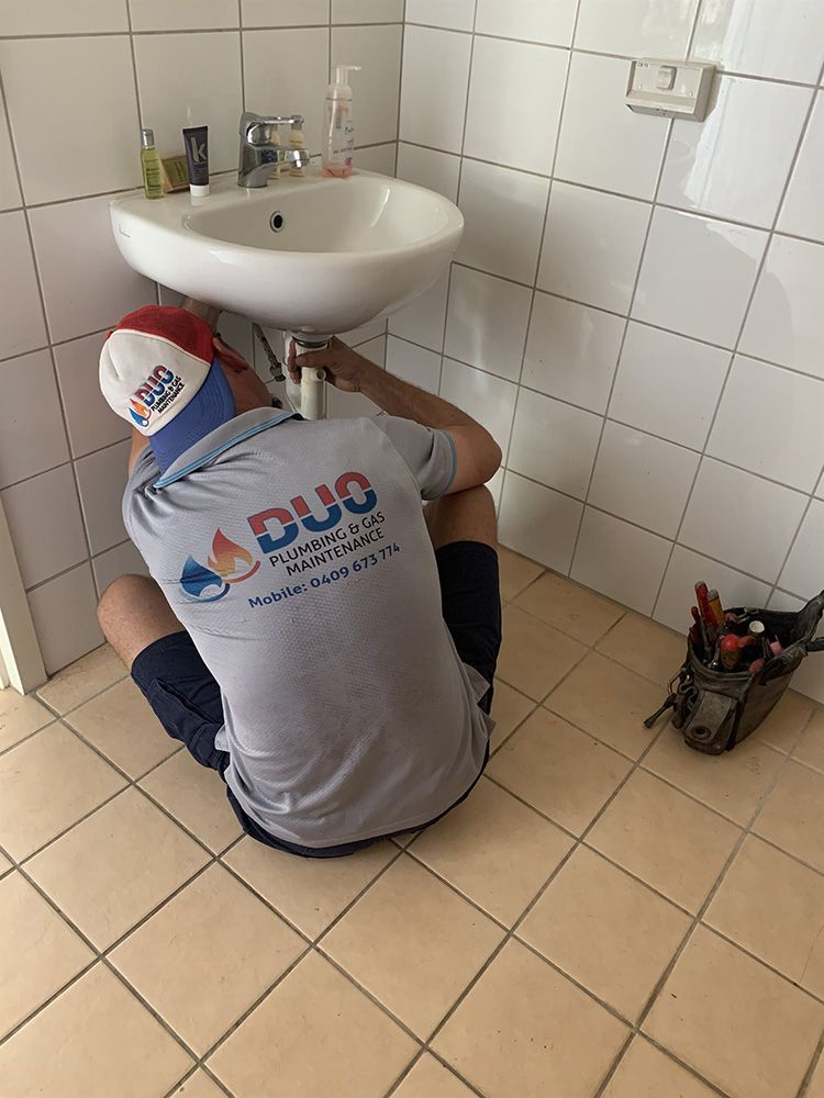 Glen fixing sink — Plumbers & Gas Fitters in Coconut Grove, NT