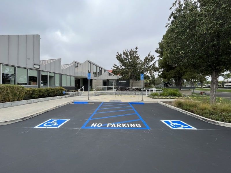 There is a handicapped parking spot in front of a building.