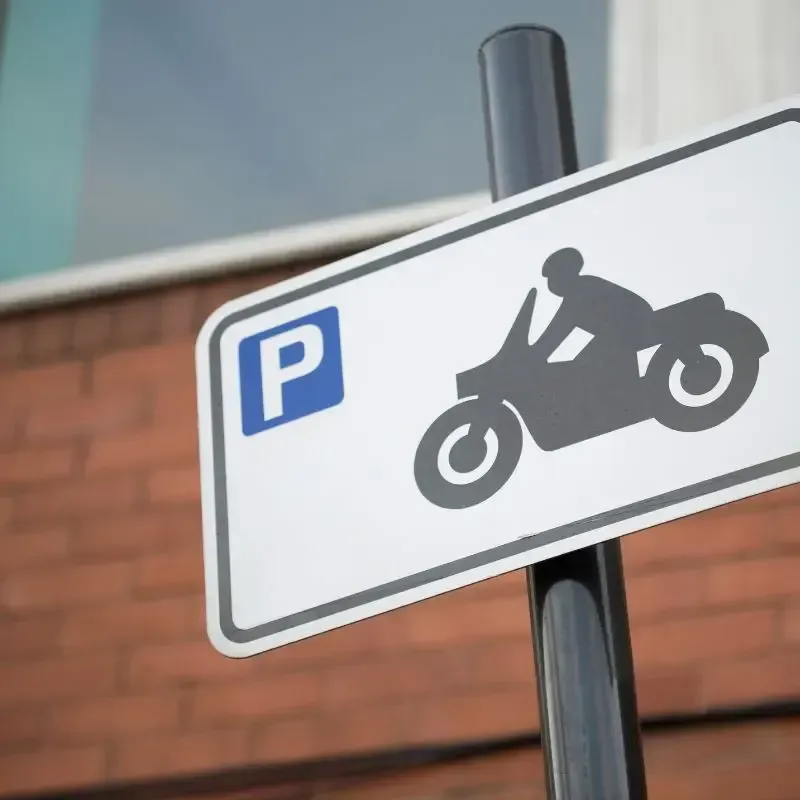 A parking sign with a motorcycle on it