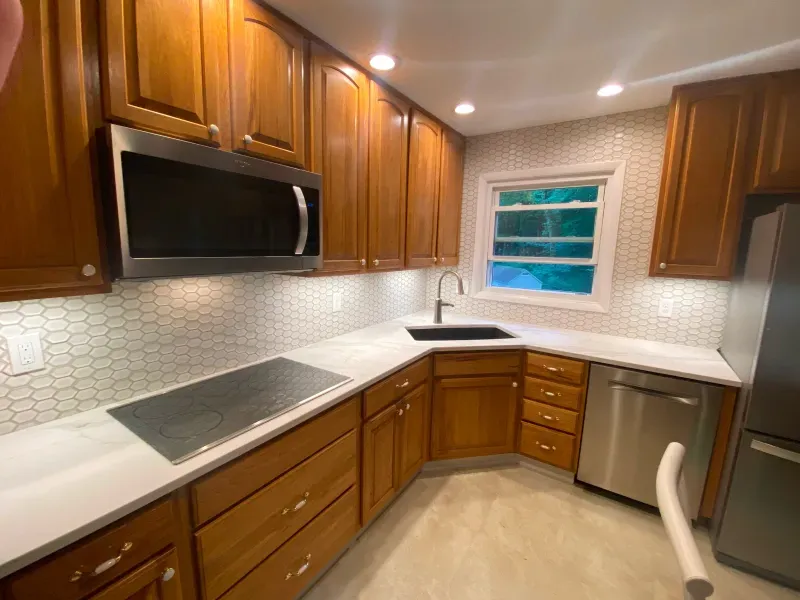 A kitchen with wooden cabinets and stainless steel appliances