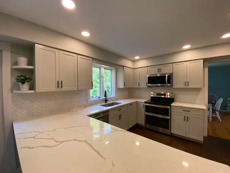 A kitchen with white cabinets and stainless steel appliances.
