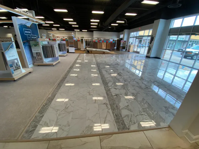 A large room with a marble floor and a lot of windows