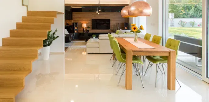 There is a dining table and chairs in the middle of the room.