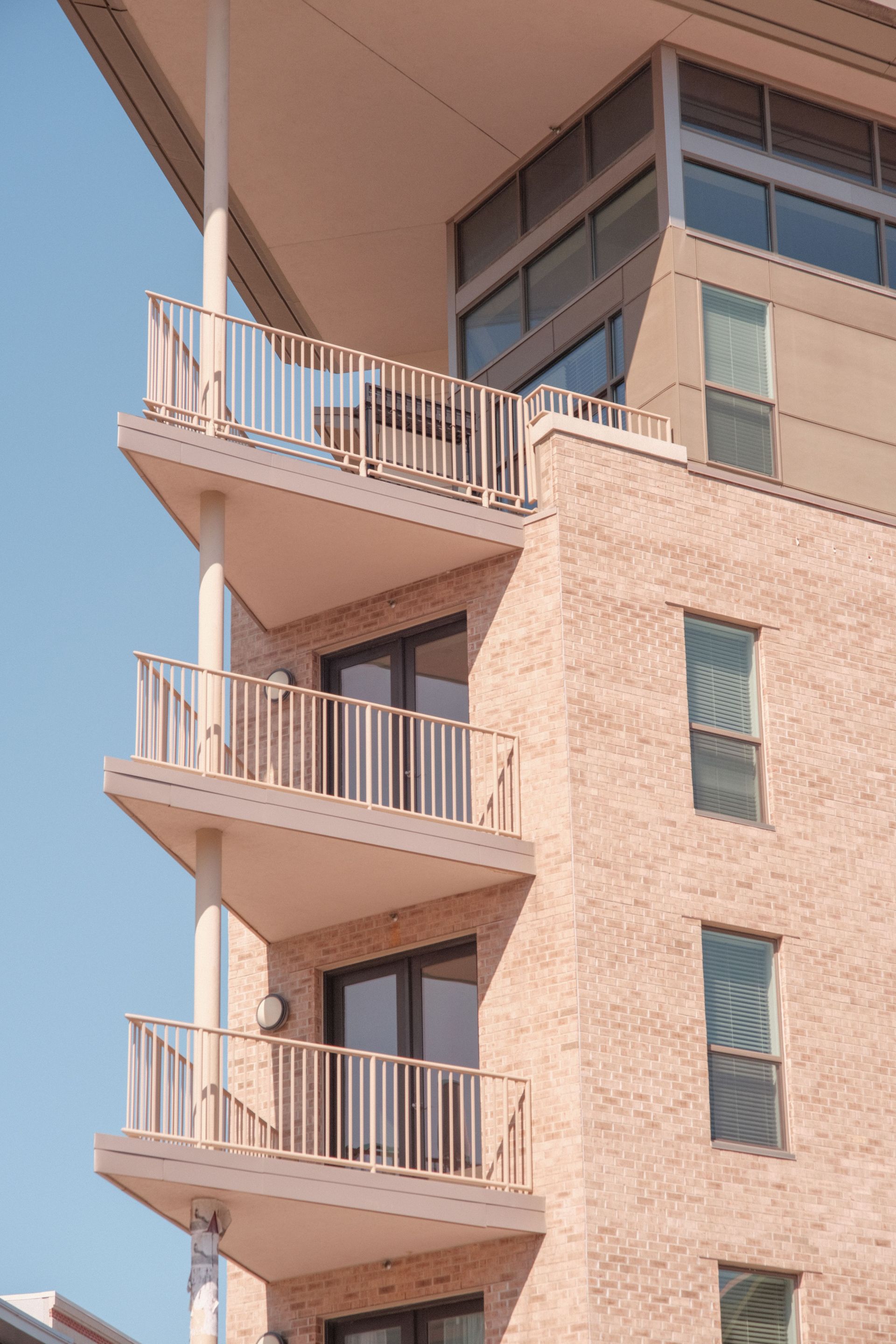 Modern apartment building with balconies against a blue sky