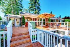 white aluminum railing surrounding a large wooden back deck