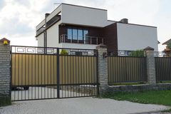 black metal sliding gate with modern decoration at top