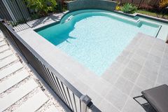 simple black fence between home and pool landing